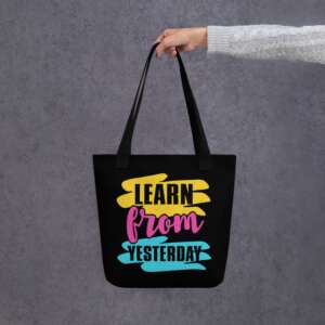 black tote bag with colorful and bold printed words learn from yesterday