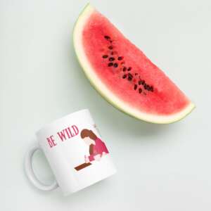 white glossy mug with words be wild